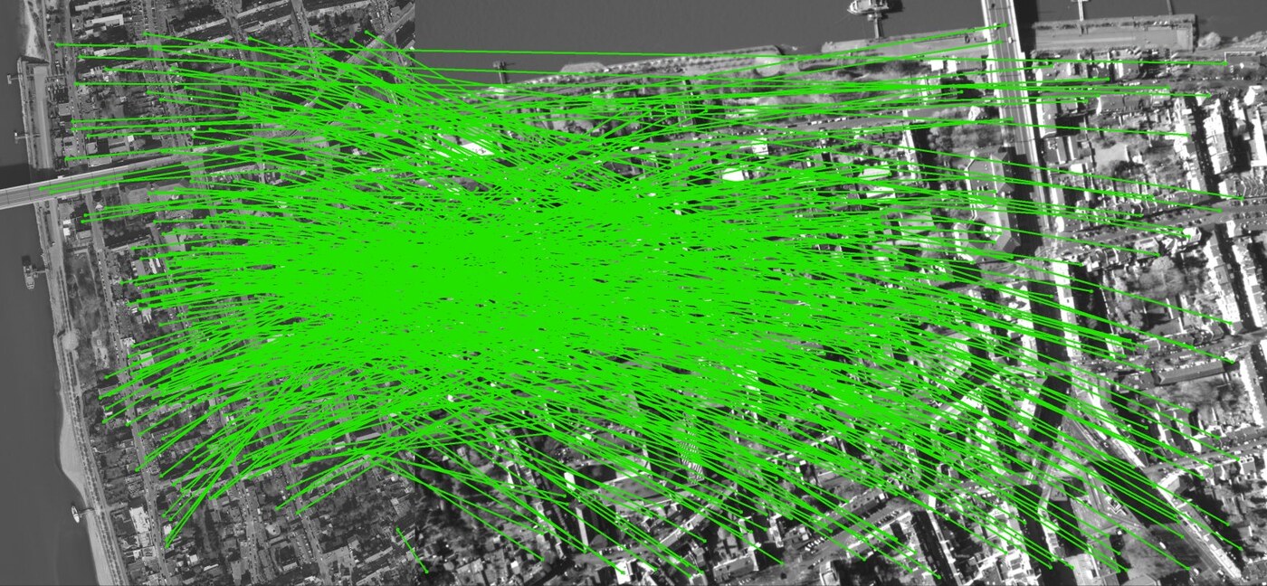 Geometrically verified matches between the orthoreference and an aerial query over artificial surfaces